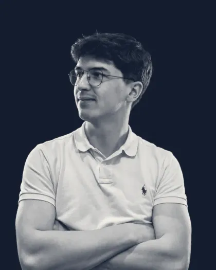 Portrait of Valentin Phu, arms crossed, looking to the left